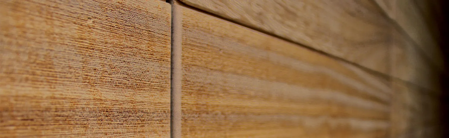 Gros plan sur la texture et le veinage naturel d'un bardage en bois exotique
